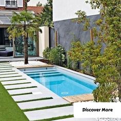 a backyard with a swimming pool surrounded by grass