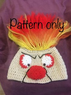 a crocheted hat with red and yellow hair