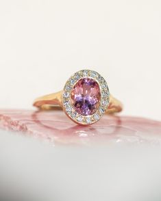 *One of a Kind* hand-carved 14k Yellow Gold ring, set with a stunning oval Pink Tourmaline, surrounded by a halo of White Diamonds. Center Tourmaline is approx. 6 x 8mm and 1.38 ct. Created to inspire deeply devoted unconditional love, reminding you of your innate worthiness and beauty, and to harmonize your strength, softness and power. Natural inclusions may be present within the stone. 💌 Please write desired size (between 4-8) in *Notes* section at checkout. * Pink Tourmaline is amazing for Oval Sapphire Ring With Halo, Heirloom Oval Tourmaline Ring, Oval Tourmaline Halo Setting Jewelry, Oval Tourmaline Jewelry With Halo Setting, Oval Tourmaline Ring With Center Stone, Heirloom Oval Sapphire Ring With Halo Design, Oval Sapphire Ring With Halo Setting In Heirloom Style, Heirloom Oval Halo Ring With Bezel Setting, Beacon Of Light