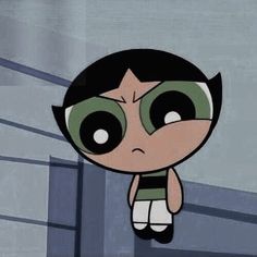 an animated girl with black hair and green eyes is hanging from the ceiling in front of a building