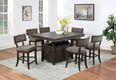 a dining room table with six chairs around it