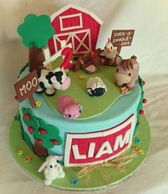 a cake with farm animals on it and a sign that says mooo, i am