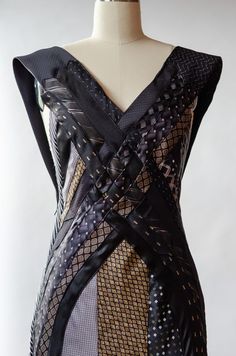 a dress on a mannequin with black and gold patterns