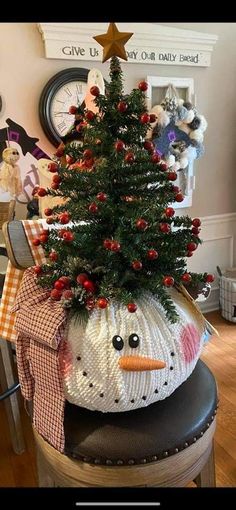 a decorated christmas tree sitting on top of a stool