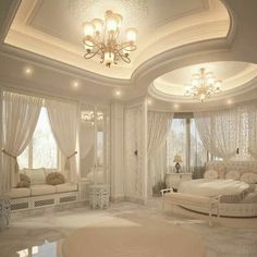 a bedroom with white furniture and chandelier in the ceiling, along with windows