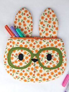 an animal shaped pencil case with glasses on it