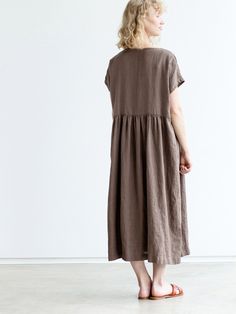 "Handcrafted Oeko-Tex Standard certified 100% European linen smock dress ideal for everyday wear. Perfect for springtime or chilly summer days. Always dress to kill! Neckline: round Silhouette: shift Length: ±48\"/120cm (we can make adjustments) Sleeve length: short Pockets: side seam Details: *Colour shown: moss green/ wood brown/ blue *Model is wearing size M *Medium weight *Maternity-friendly *Relaxed fit *Not-ironed (and no need to) *Handmade by @LinenCloud Easy care: - Machine wash gentle - Casual Brown Linen Dress With Relaxed Fit, Brown Linen Dress For The Beach, Casual Brown Linen Maxi Dress, Casual Flax Color Relaxed Fit Dress, Brown Linen Dresses With Pockets, Linen Lagenlook Maxi Dress With Relaxed Fit, Lagenlook Linen Maxi Dress With Relaxed Fit, Relaxed Fit Linen Dress In Flax Color, Oversized Linen Dresses For Daywear