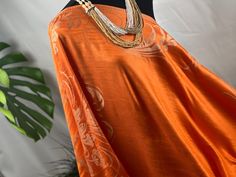 Elevate your wardrobe with the vibrant and radiant energy of our Vibrant Orange Pashmina Shawl. This luxurious wrap features elegant cream floral patterns, making it a true statement piece. The striking orange hue is perfectly complemented by the soft cream motifs, adding a touch of versatility to this must-have accessory. Crafted with the utmost care and attention to detail, this shawl is made from the finest pashmina fibers, ensuring a heavenly softness against your skin. It's the perfect companion for brisk mornings and cool evenings, providing a lightweight yet cozy embrace. Measuring 71.00x28.00 inches, this shawl offers ample space for you to wear it in different ways. Drape it over your shoulders for a traditional shawl look, or style it as a scarf to add a touch of elegance to your Luxury Orange Sheer Dupatta, Luxury Cream Pashmina Shawl, Luxury Cream Pashmina Shawl In Traditional Drape, Radiant Energy, Pashmina Shawl, Vibrant Orange, Floral Patterns, Shawl, Floral Pattern