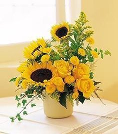 a vase filled with yellow flowers and stars