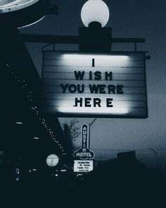 a neon sign that says i wish you were here