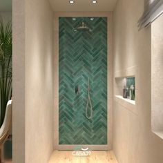 a bathroom with green tiles and a shower head in the corner next to a window