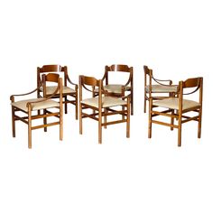 a set of four wooden chairs with leather seats