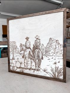 a drawing of two men riding horses in the desert