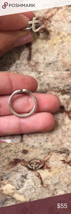 a person holding a ring in their hand on top of a marble counter with the price tag