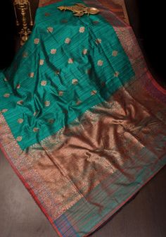 Embrace elegance with this Rama Green Dupion Banarasi silk saree. The rich hue is beautifully complemented by an antique zari border and intricate floral zari buttas. The richly textured Dupion silk, combined with the classic antique zari work, creates a timeless and sophisticated look. Ideal for festive occasions and special events, this saree offers a perfect blend of traditional charm and modern style. SILK MARK CERTIFIED This saree is ready to wear with fall and pico done. Handmade silk tass Silk Tassels, Banarasi Silk Saree, Dupion Silk, Zari Work, Social Events, Blouse Fabric, Saree Wedding, Silk Saree, Saree Designs