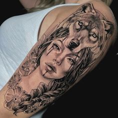 a woman with a wolf tattoo on her arm