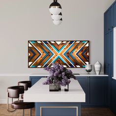 a modern kitchen with blue cabinets and white counter tops is featured in this image, it has an abstract painting on the wall