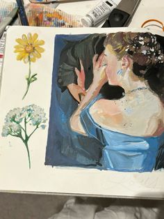 a painting of a woman in a blue dress with flowers on her left side and other art supplies nearby