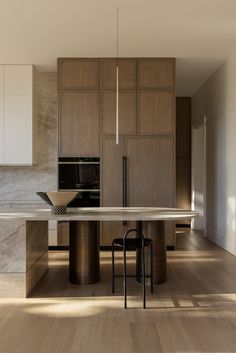 a modern kitchen with wooden cabinets and marble counter tops