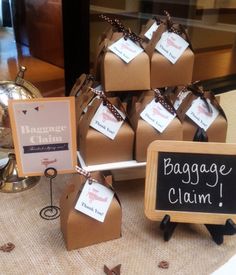 there are many small bags on the table with tags attached to them, and each bag has a name tag that says baggage claim