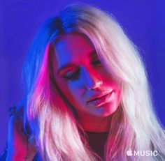 a woman with long blonde hair and blue lighting