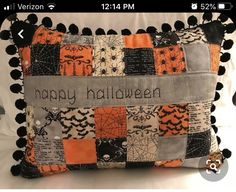 an orange and black pillow that says happy halloween