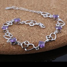 Features: Made by using genuine 925 sterling silver that prevents scratches and fading to the bracelet The bracelet offers an eye-catching heart shape design that bound to catch the attention You will be well recognized in parties with the help of purple rhombus stone of the bracelet With the help of lobster clasp, it is quite easy to wear and remove in any place easily No risk of developing any skin allergies, as it offers a box type chain Description: Be a trendsetter in the market by wearing Purple Heart Charm Bracelet For Valentine's Day, Valentine's Day Purple Bracelet With Heart Charm, Purple Heart Bracelet For Valentine's Day, Purple Sterling Silver Bracelet Gift, Sterling Silver Purple Bracelet As Gift, Purple Cubic Zirconia Bracelets As Gift, Purple Cubic Zirconia Bracelets For Gift, Purple Cubic Zirconia Bracelet As Gift, Purple Sterling Silver Bracelet As Gift