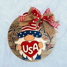 a wooden ornament with the word usa on it and an american flag heart