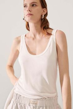 Silk laundry jersey scoop tank lightweight with stretch and featuring a scoop neck. designed for a close comfortable fit. ideal for layering or solo wear.    - material: 100% silk jersey  - lightweight with stretch  - scoop neck  - close fit  - oeko-tex certified  - model wears size medium Everyday Modal Camisole With Scoop Neck, Summer Modal Camisole With Scoop Neck, Modal Tank Top For Everyday, Everyday Modal Tank Top With Scoop Neck, Everyday Modal Tank Top, Everyday Modal Tank Camisole, Modal Tank Camisole, Chic Scoop Neck Tank Top For Loungewear, Stretch Modal Tank Top With Scoop Neck