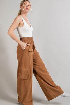 Fit for a day of city explorations, these wide leg mineral washed cargo pants are the epitome of style and functionality. Their distinctive mineral washed finish gives them a worn-in, vintage look that's both trendy and timeless. Equipped with multiple pockets, these pants offer ample storage space while maintaining a comfortable fit, making them a practical choice for outdoor adventures or casual outings. Product Details Material: Self: 100% Cotton. Fit: True to size. Inseam: 31.5” (size Small). Rise: 10.5”Fabric: Stretch cotton. Features: High waisted, wide leg, cargo pockets, elastic waistband, mineral wash. Model: 5’8” / Wearing a size Small. Care: Machine wash cold, gentle cycle. Tumble dry low. Shipping & Returns Free Shipping on U.S. orders +$100. We want you to be 100% satisfied wi Casual Linen Cargo Bottoms, Utility Wide Leg Linen Bottoms, Brown Wide-leg Cargo Jeans With Side Pockets, Wide Leg Brown Cargo Jeans With Side Pockets, Casual Linen Pants With Multiple Pockets, Wide Leg Linen Parachute Pants With Cargo Pockets, Casual Linen Cargo Pants, Casual Washed Brown Bottoms, Casual Brown Washed Bottoms