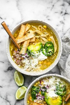 two bowls filled with soup and topped with tortilla chips