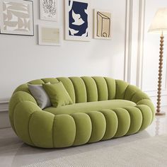 a green couch sitting on top of a white floor