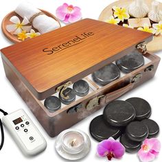 an open wooden box containing several different types of spa items with orchids in the background