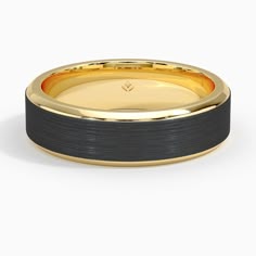 a black and gold wedding band with an inlay on the inside, set against a white background