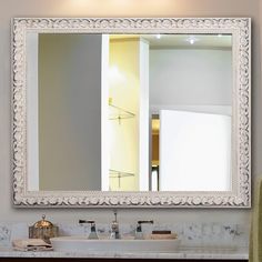 a bathroom sink sitting under a large mirror