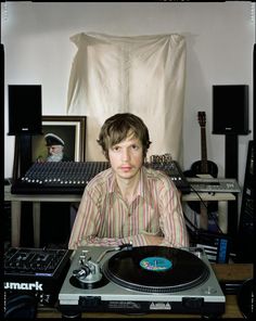 a man sitting in front of a record player