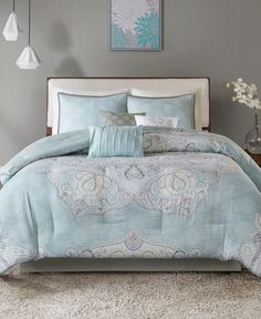 a bed with blue and white comforters in a bedroom