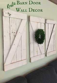 two white barn doors with a wreath hanging on the wall