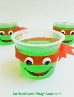 three plastic cups with faces painted on them