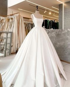 a white wedding dress on display in a store