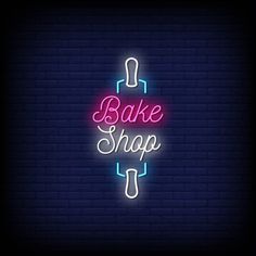 a neon sign with the words bake shop on it in front of a brick wall