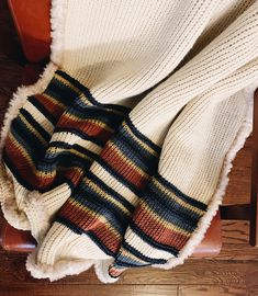 a blanket that is laying on top of a chair