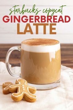 there is a cup of coffee with gingerbread latte in it and a cookie on the side