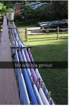 a fence with several towels hanging on it and the words my wife is a genius