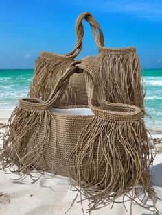 👜Crochet raffia tote bag is completely hand knitted natural paper rope raffia. 🏖️Our multipurpose bags are suitable for daily use such as beach and shopping.  Thanks to the pocket on the lining of the product, you will be able to organize your beach bag by placing your sun creams, wet and dry swimsuits, keys, wallet, glasses, etc.  You can also use it multipurpose for your other needs. It is a useful product that you can easily fit all kinds of things you may need on the beach.  👜The product Raffia Beach Bag, Crochet Beach Bag, Elegant Handbags, Raffia Tote Bag, Crochet Beach Bags, Summer Tote Bag, Summer Tote Bags, Crochet Fringe, Straw Beach Bag