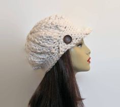 This is made to order. I crocheted this cap with Chunky Cream Yarn. This hat is thick and warm! It has a crocheted visor with two buttons. Depending upon availability the buttons will be cream or natural wood color. This hat will fit most adult or teen heads. The buttons shown may differ depending upon availability. If you would like a different color just let me know. Some of the other colors I have are black, black tweed, brown, brown tweed, oatmeal tweed, taupe, gray tweed, charcoal gray, dar Beige Beanie, Chunky Crochet Hat, Crochet Newsboy Hat, Cream Hat, Tan Hat, Beige Crochet, Tweed Yarn, Toddler Sweater