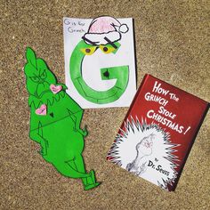 two children's books are laying on the ground next to each other, one is green and the other is red