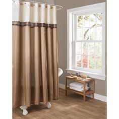 a bathroom with a shower curtain and wooden flooring