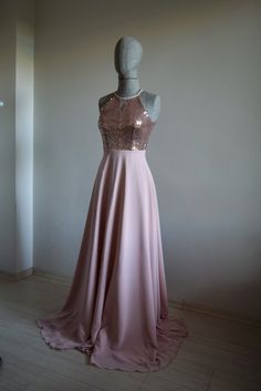 a mannequin wearing a pink dress with gold sequins on it's back