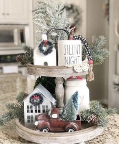 a tray with christmas decorations and candles on it in the middle of a kitchen counter